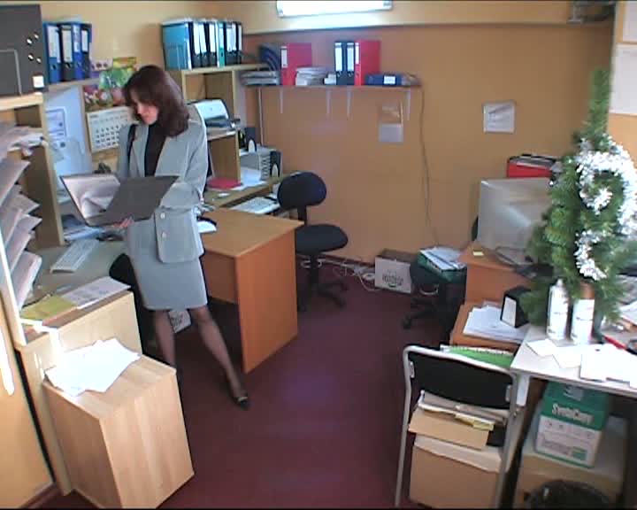Hidden cam brunette in office