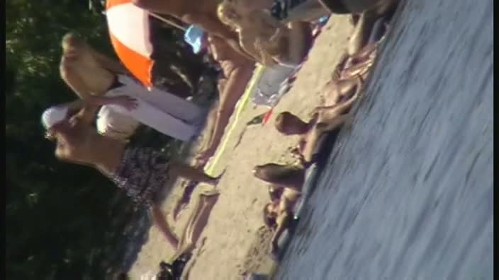 Cute brunette with black thong in the beach video