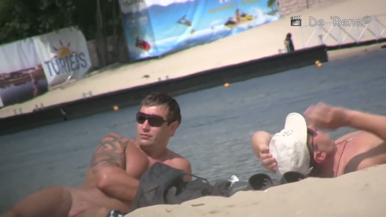 Wide spread pussy lying on a beach in this spy cam video