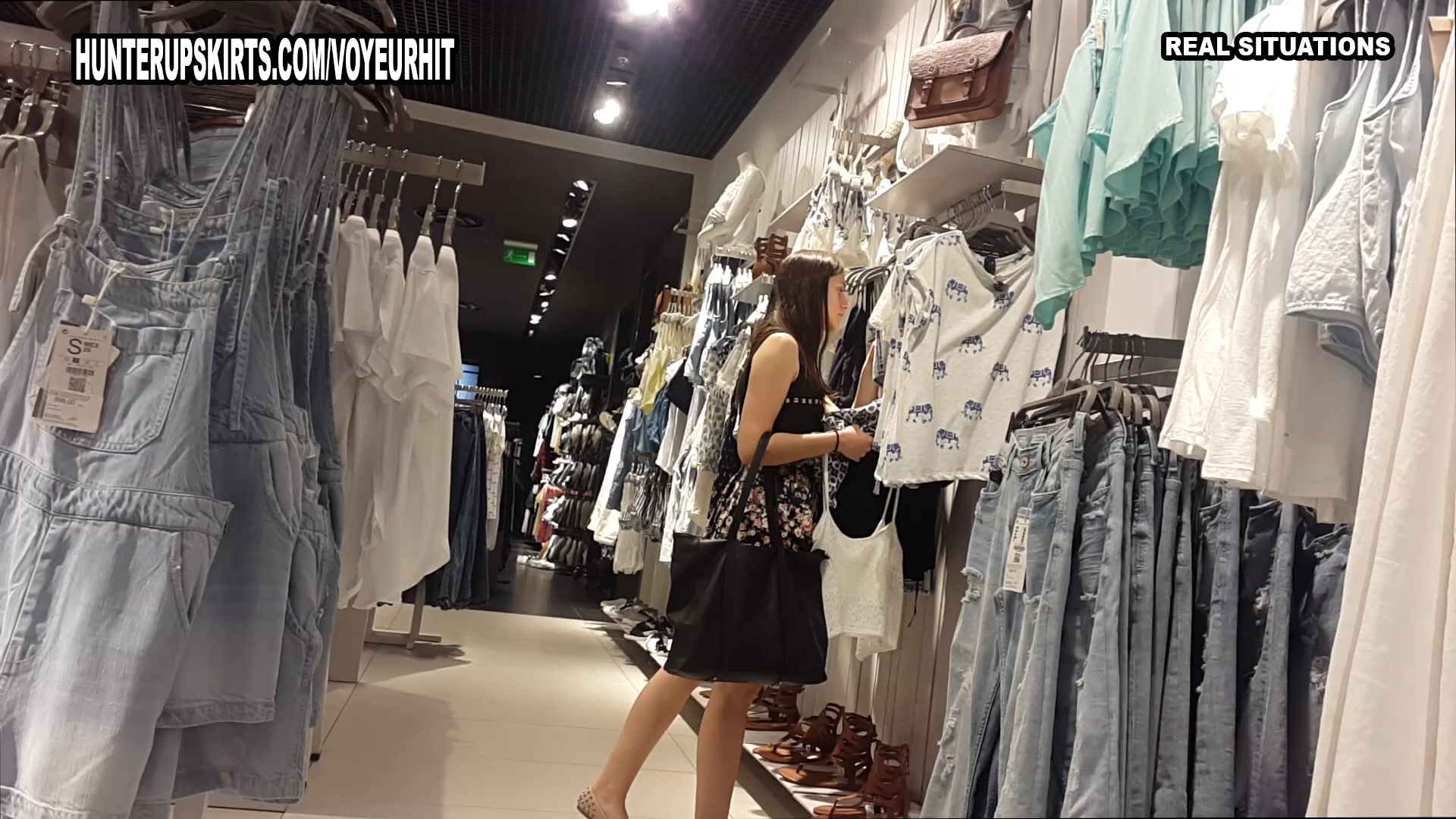 Beautiful young woman in mini-skirt caught in the clothes store