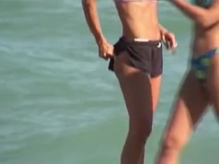 Sporty girl in sexy bra and candid shorts on the beach 01m