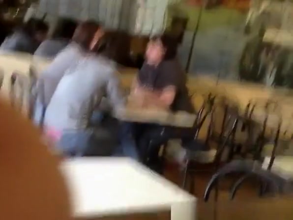 Pink thong exposed at cafe table