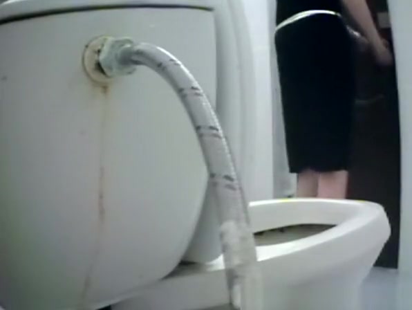 Woman takes a piss in toilet