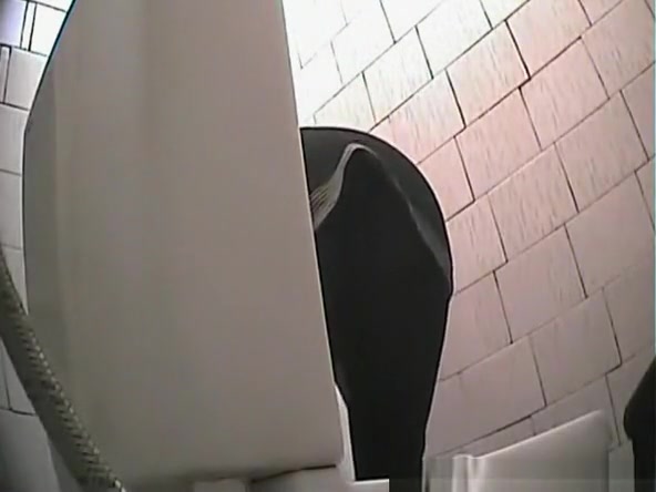 Brunette chick spied in public toilet pissing