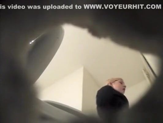 Blonde girl in toilet with spycam