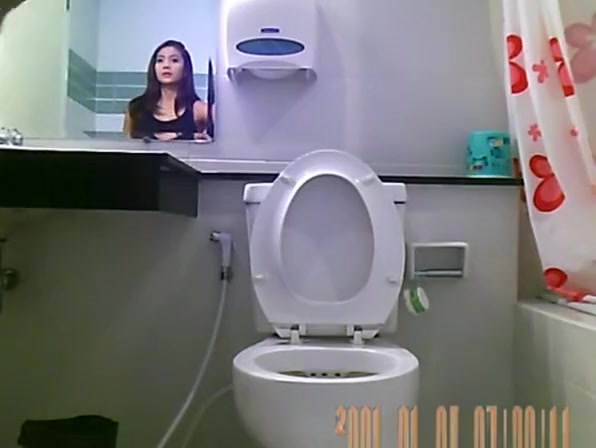 Sexy hot brunette spied in bathroom peeing