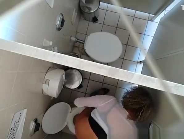Hidden camera in public toilet ceiling