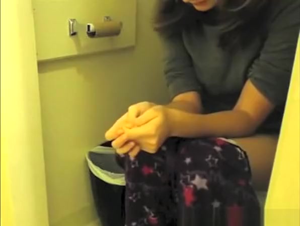 Girl pulls her pajama down to pee