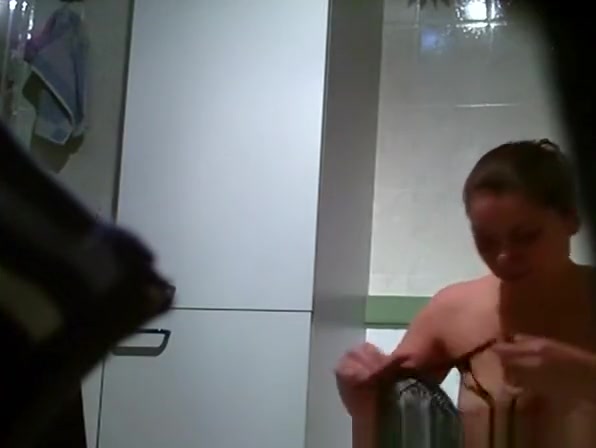 Busty chick spied in bathroom taking a pee