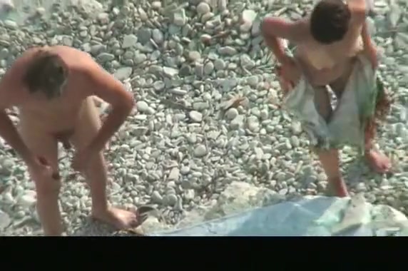Nude couple spied in rocky beach