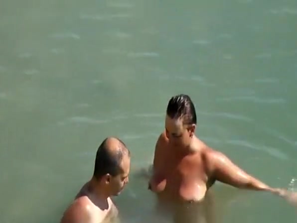 Nudist couple enjoying the fresh water