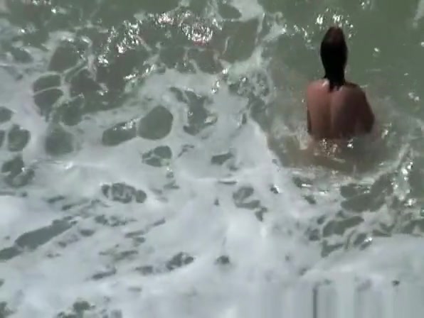 Small boobs nudist swimming in the water