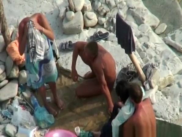 Two nudist couples in beach