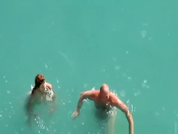 Nude couple fucking in water