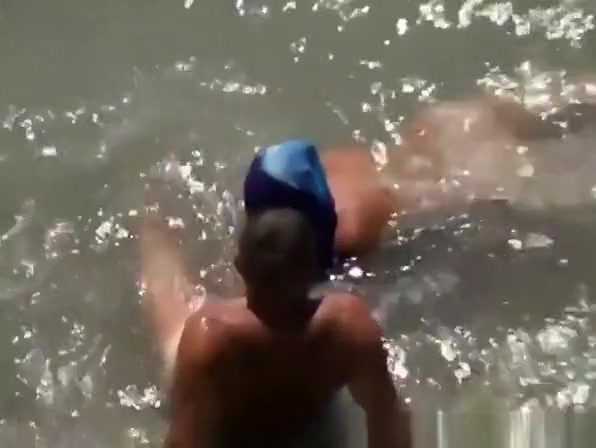 Woman blows her man's cock in the water