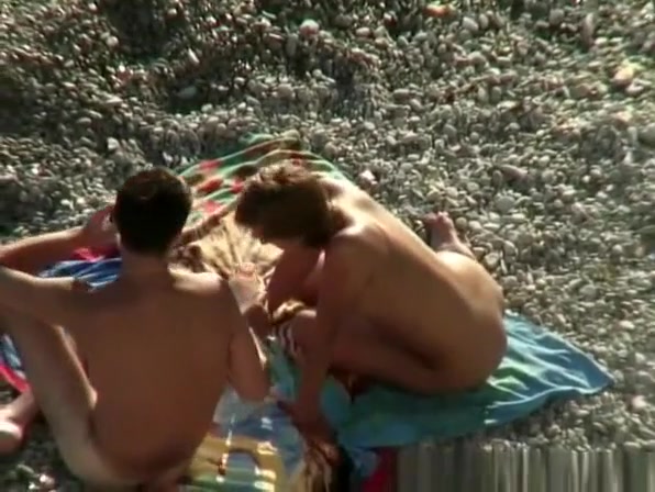 Nude woman rides her man's dick in beach