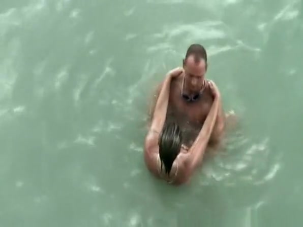 Tattooed nudist fucked in the water