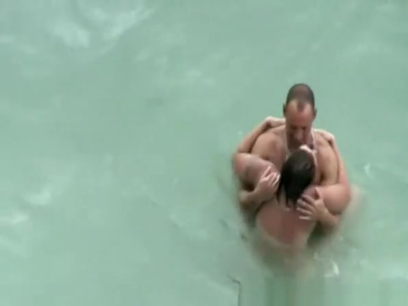 Tattooed nudist fucked in the water