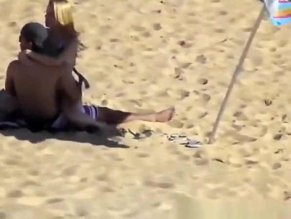 Blonde girl rides her boyfriend’s dick in beach