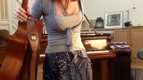 Redhead playing guitar down blouse and cleavage
