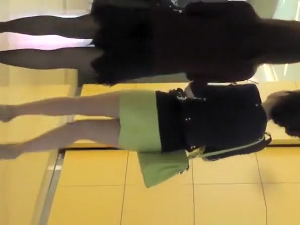 Asian woman in green short skirt