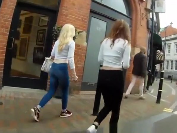 Blonde and brunette teens wearing tight pants
