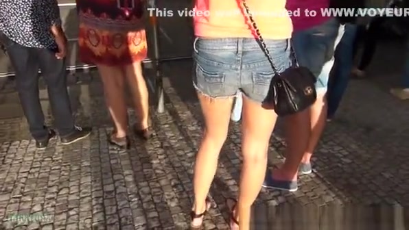 Girl in denim shorts waiting for crossing road