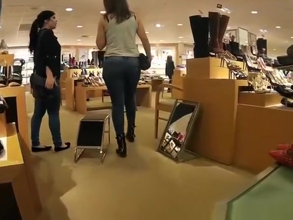 Girl in tight jeans pants at the shoe store