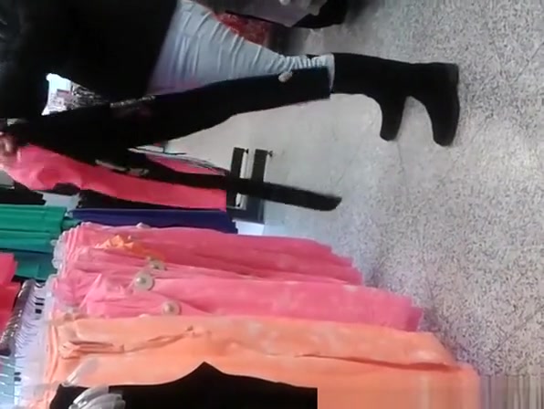 Woman in tight jeans pants at clothes store