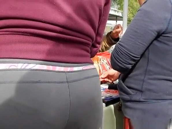 Woman with big ass in tight gray pants