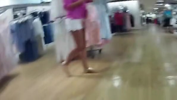 Woman in black dress upskirted in shopping mall