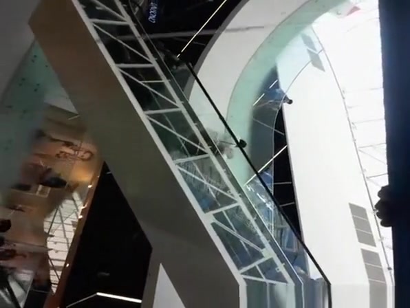 Upskirted in the shopping mall rolling stairs
