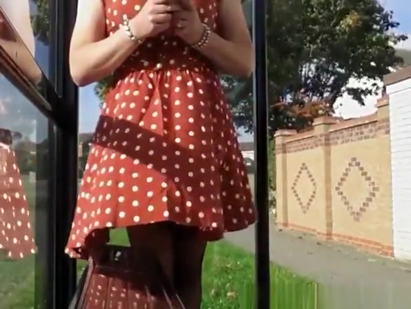 Wind lifts woman's red dress exposing her