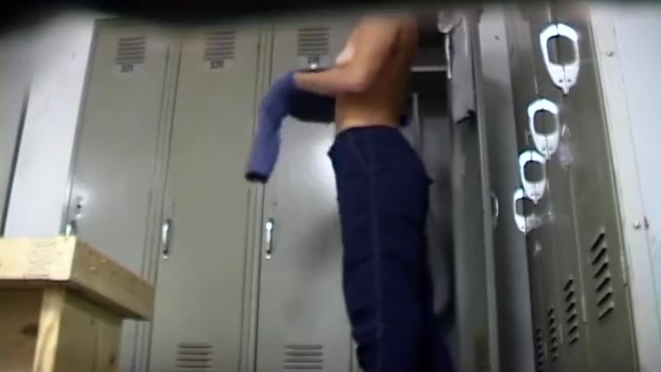 Fit chick stretches in the locker room