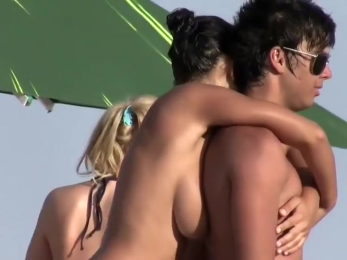 Teenage couple kissing on a beach