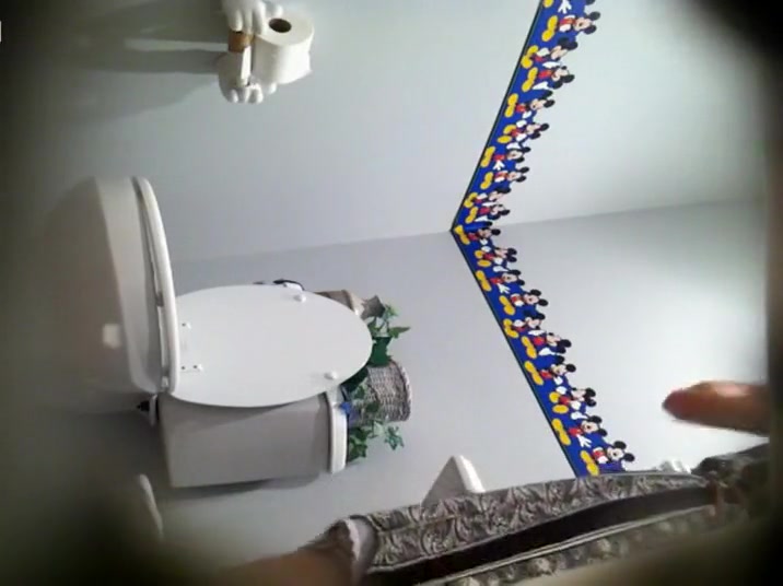 Dreamy girl spied while pissing on a toilet