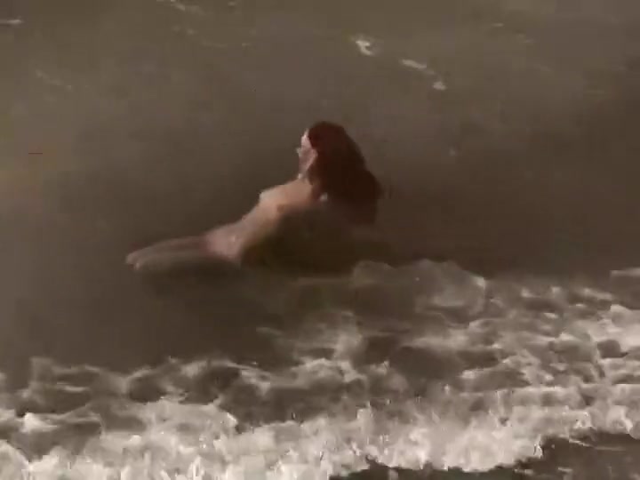 Quirky redhead fucked on a beach