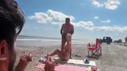 Nudist wife jerks off strangers at the beach and they cum on her