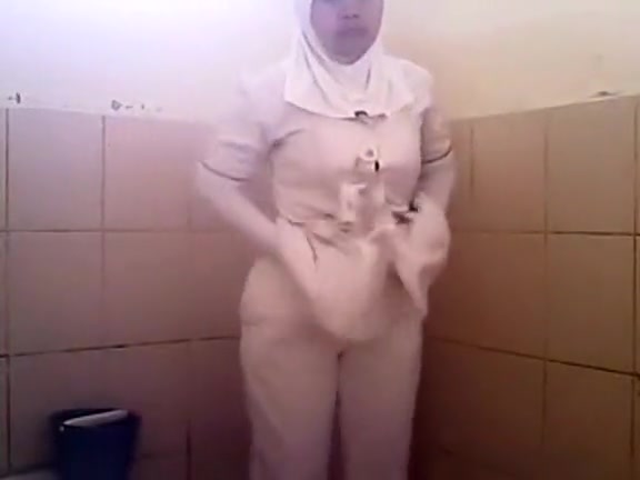 Arab woman goes pee in a public toilet