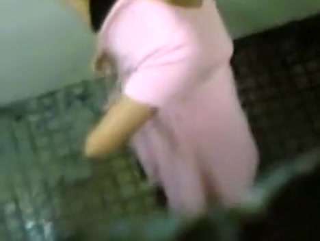 Urinating girl filmed over the bathroom wall