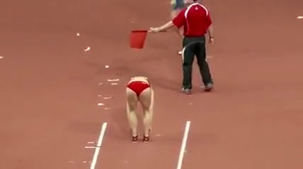 Raven-haired athletic babe competes in long jump