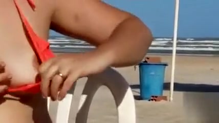 Chubby woman sets up her red bikini at the beach