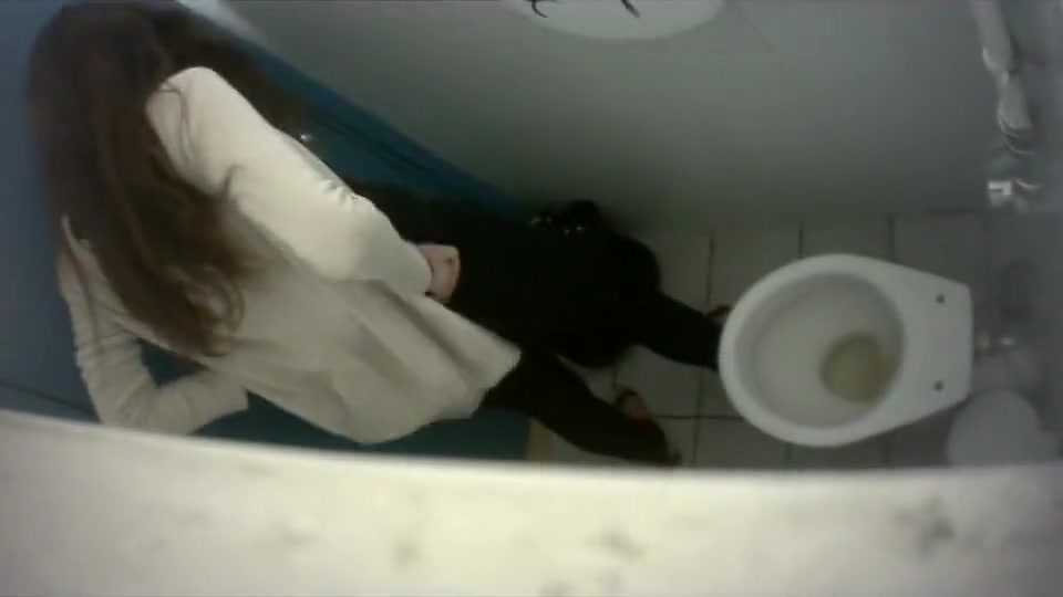 Long-haired brunette with a bubble butt takes a quick pee in the college restroom