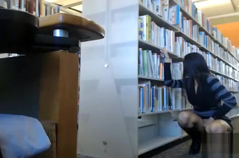 Female student makes upskirt selfie in library