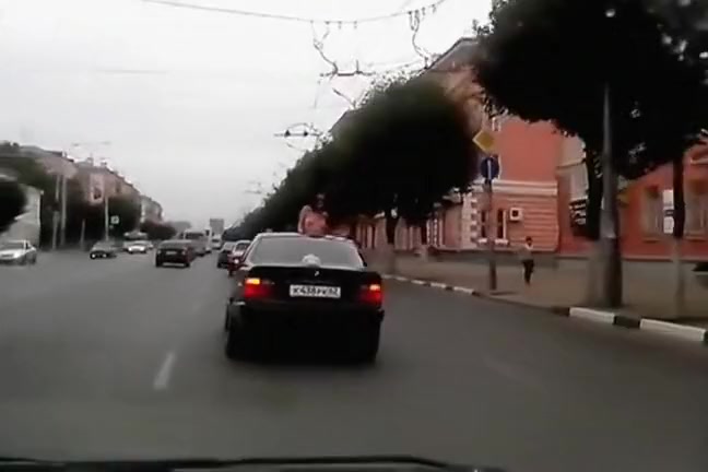 Topless babe riding in a BMW while in Russia