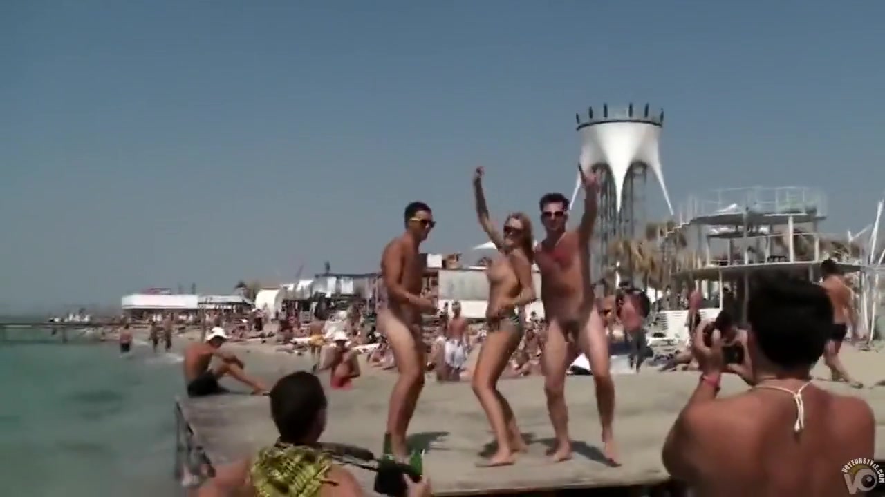 Topless babe dancing with naked guys in public