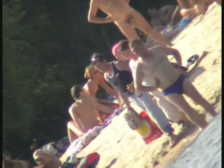 Nude spy cam on the beach with a black hair goddess in focus