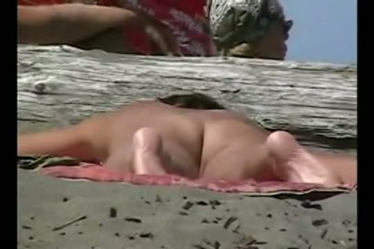 A voyeur catches a husband spanking his naked wife on the beach