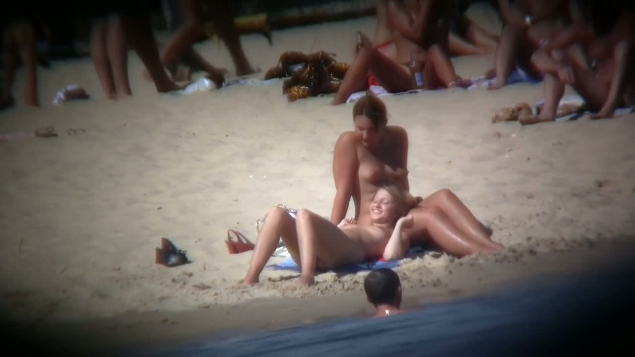 Buxom blonde filmed on a nudist beach