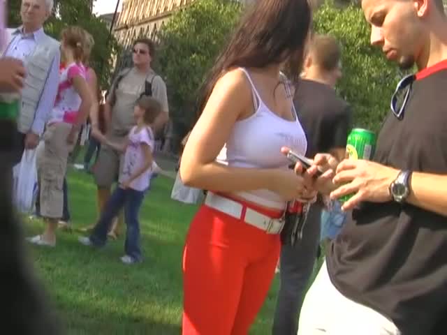 Sizzling brunette wearing bright red pants public street candid vid